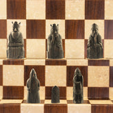 A handmade recreation of The Isle of Lewis Chess Set, the oldest known chess set.
In 1831 the sea carried away a sandbank on the Isle of Lewis uncovering a mysterious building that had been buried under the sand. A peasant working nearby found what he concluded to be a collection of Elves and Gnomes. The superstitious highlander flung down his spade and fled home in horror.